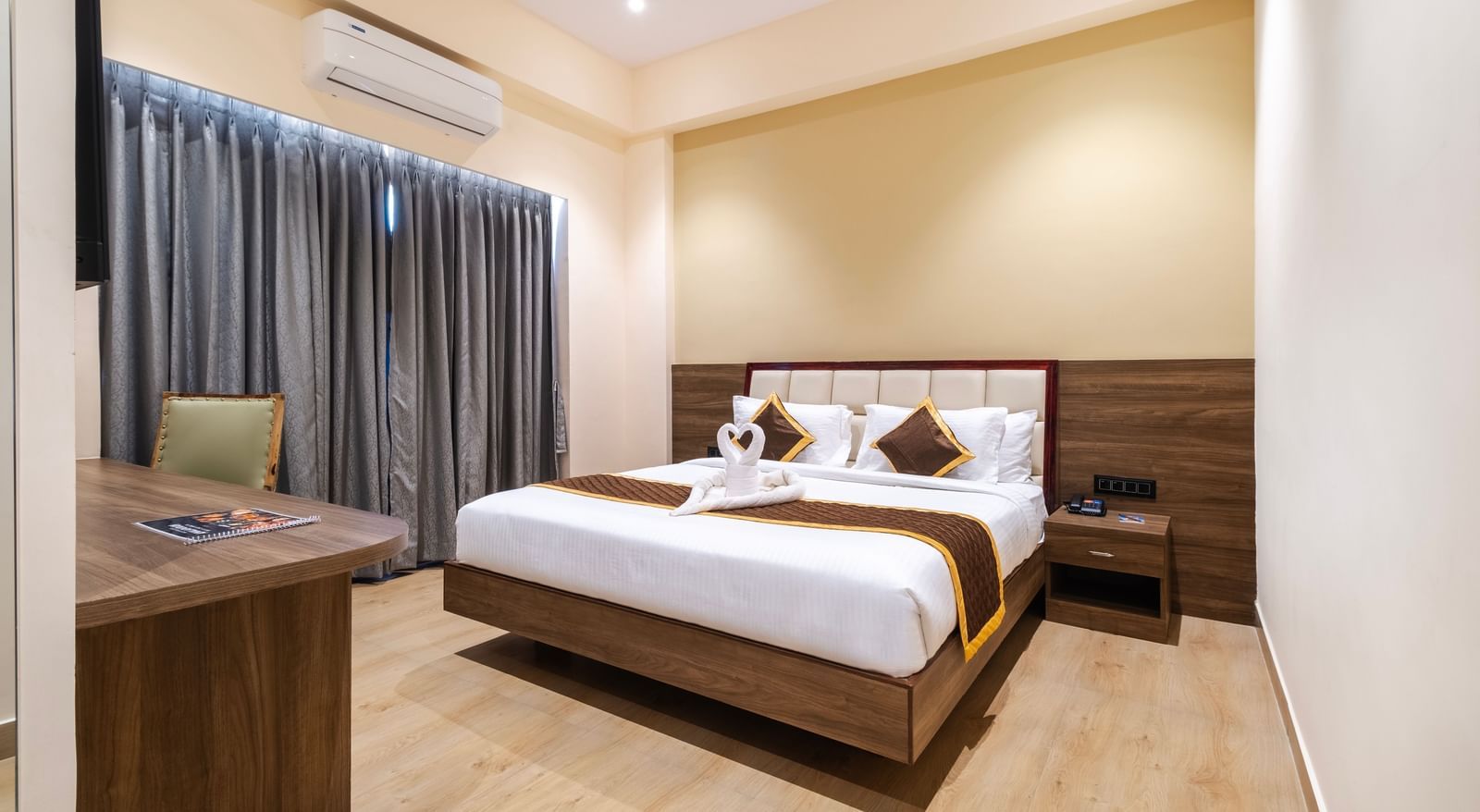 Spacious room at Monday Hotels Amalapuram Heights with elegant interiors and air-conditioning.