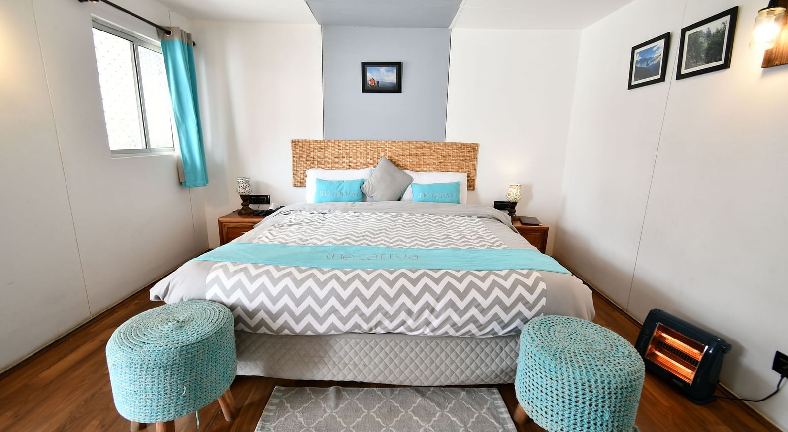 front view image of the comfortable bed with two cushioned stools in front of it - The Tattva Boutique Resort