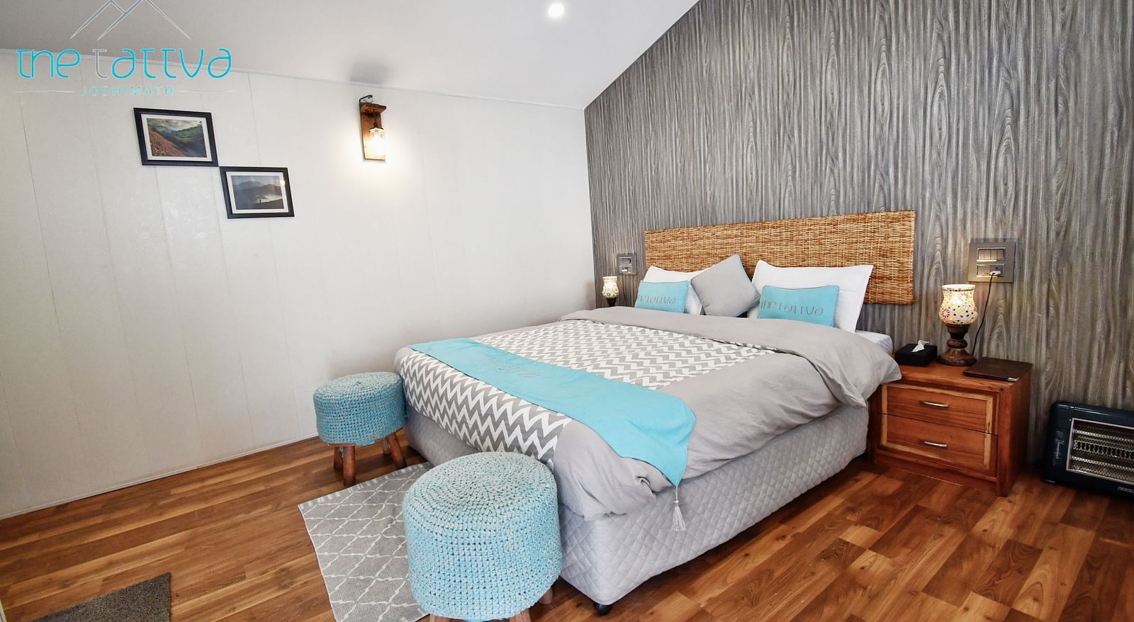 corner view image of the deluxe room with a grey coloured master wall behind the bed - The Tattva Boutique Resort