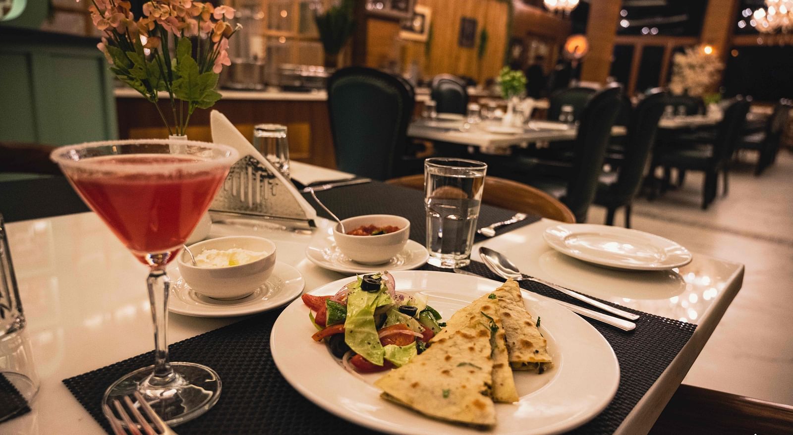image of food served on a white plate with salad served with a red coloured beverage - the tattva boutique resort