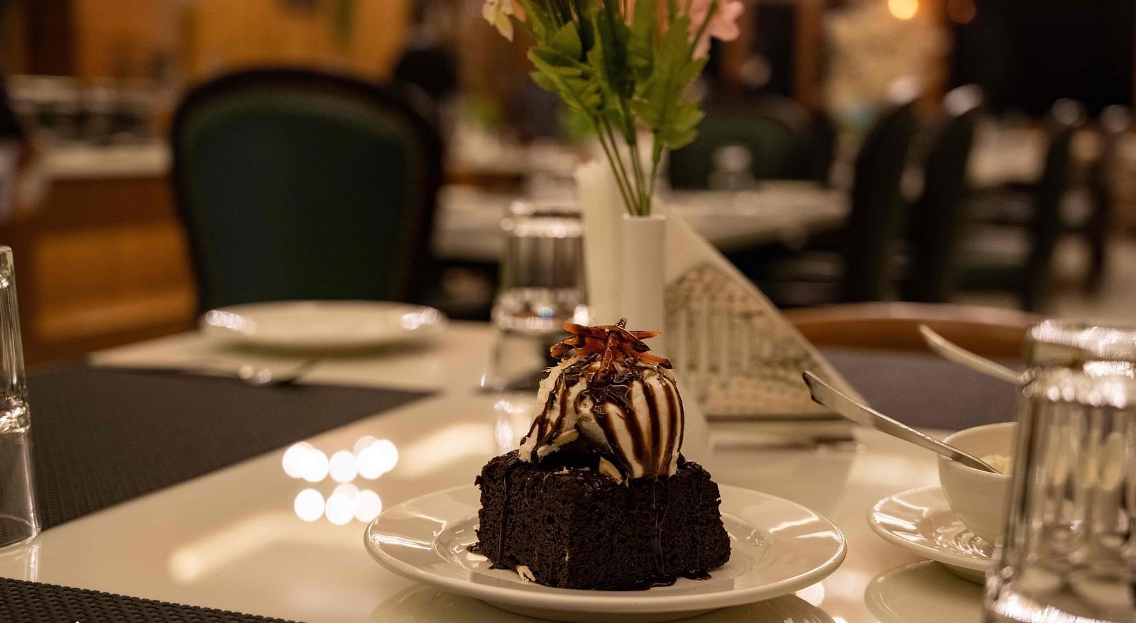 image of an ice cream scoop served with a brownie at the alpenrose restaurant- the tattva boutique resort