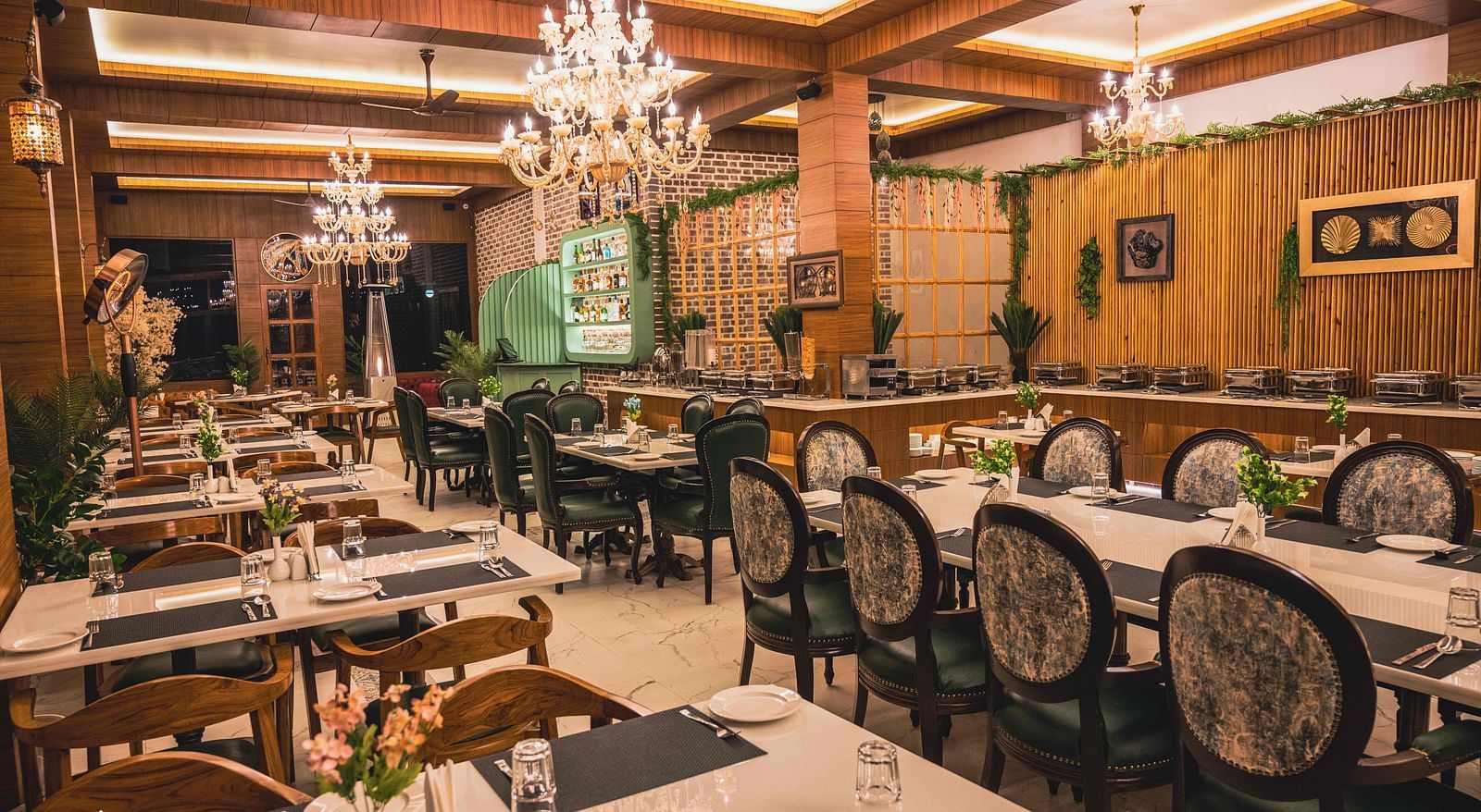 image of the alpenrose restaurant with well arranged dining area with elegant chairs - the tattva boutique resort