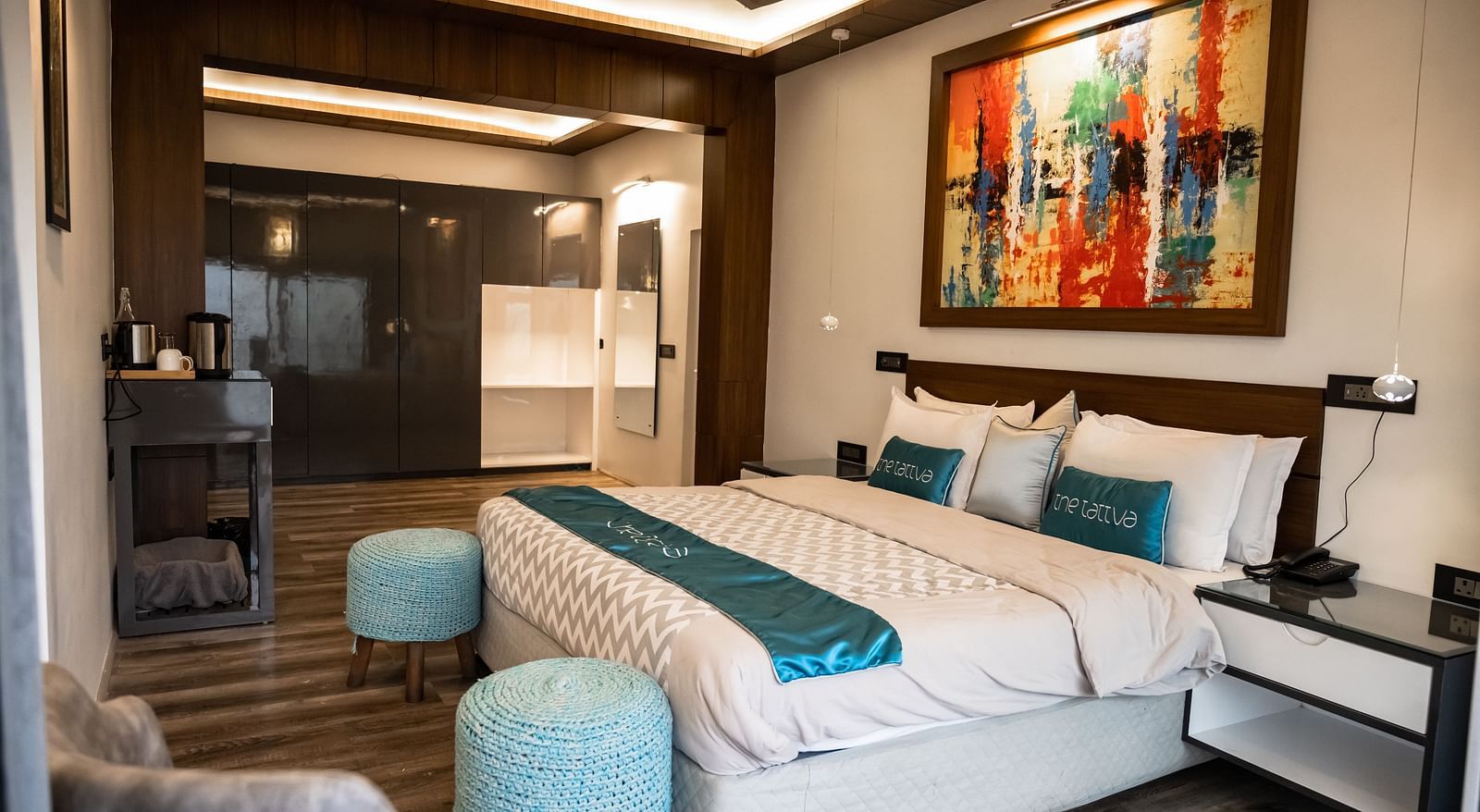 coner view image of the bedroom featuring a comfortable double bed with ample natural light at the pent house - The Tattva Boutique Resort