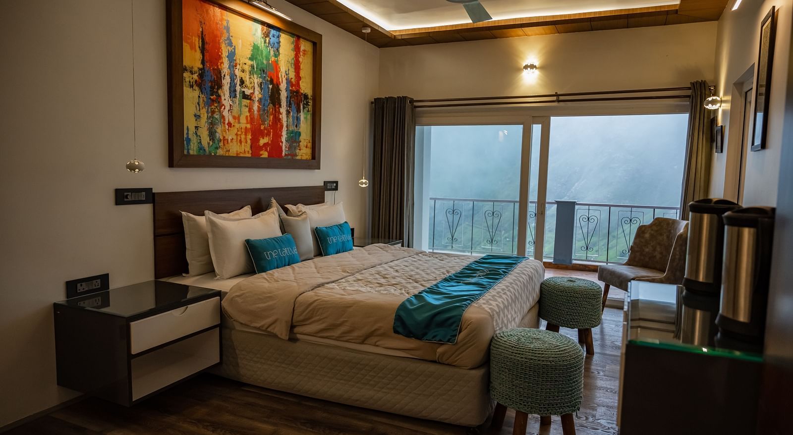 image of the bedroom at the pent house with a balcony in the far end of the room with beautiful views of the valley - The Tattva Boutique Resort