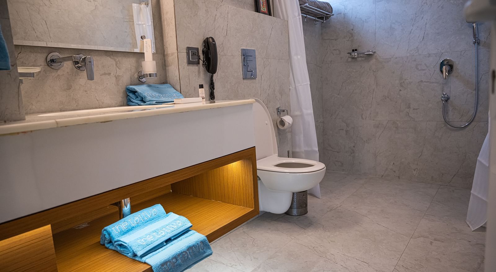 image of the bathroom taken from a lower angle featuring a wash basin and a commode in the pent house - The Tattva Boutique Resort