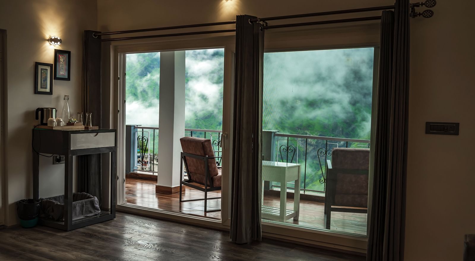 image of the balcony separated with huge french windows in the pent house with beutiful lush green views - The Tattva Boutique Resort