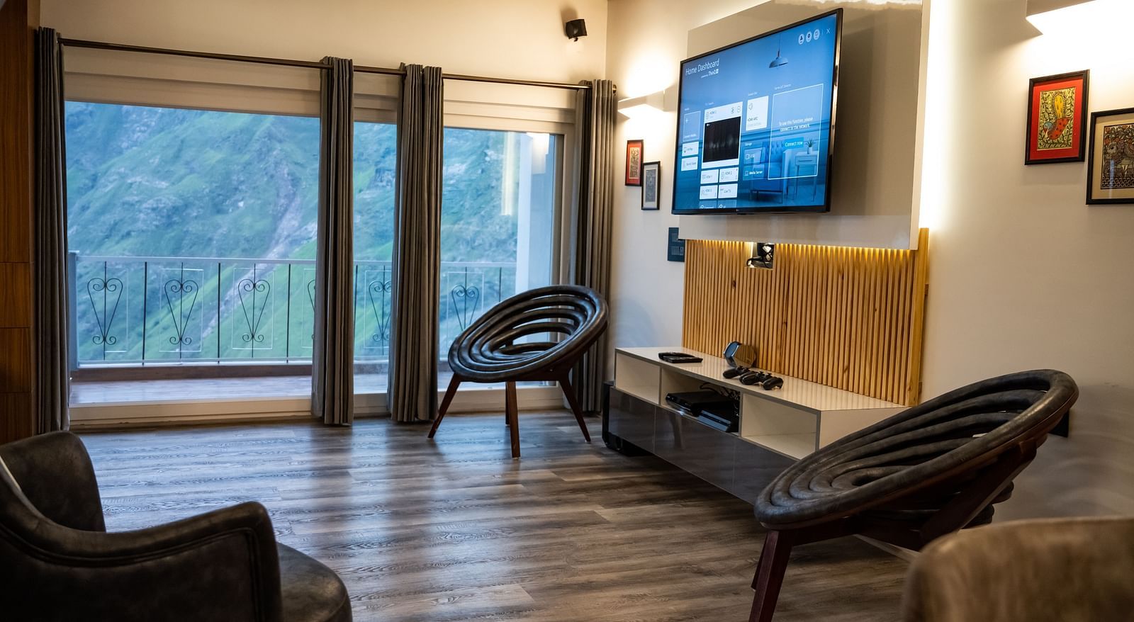 image of the living room featuring a balcony with amazing valley views and a wall mounted tv at the pent house - The Tattva Boutique Resort