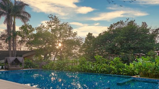 sunset view by the pool, with vibrant colours reflecting on the water at The Dukes Retreat