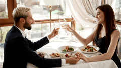 Handsome young man and attractive woman enjoying a romantic date at a restaurant. 