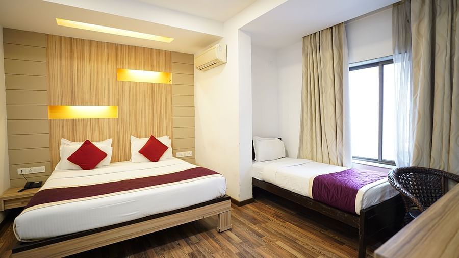 an image of executive deluxe bedroom with a an extra cot near the near at  City Centre Residency, Bangalore
