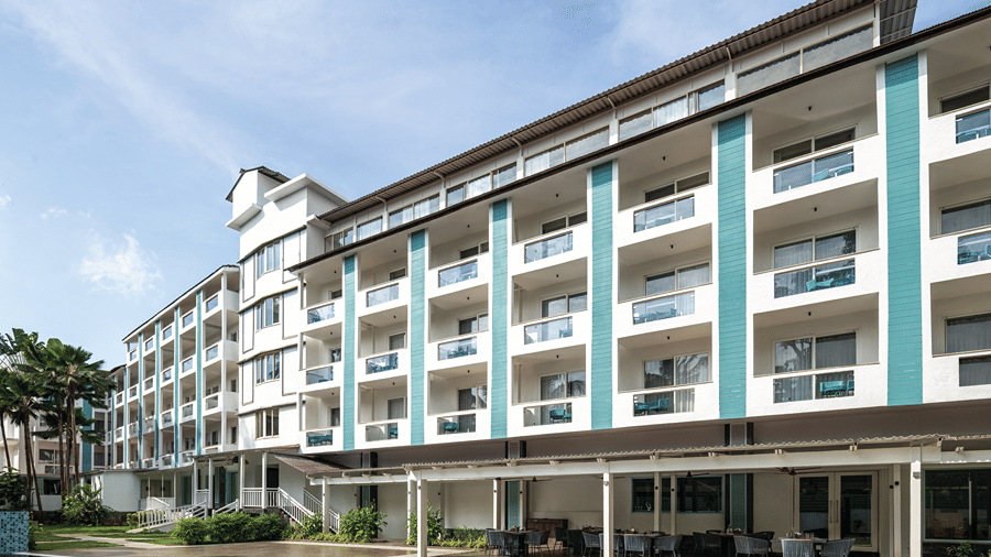Exterior view of the hotel building overlooking the swimming pool.