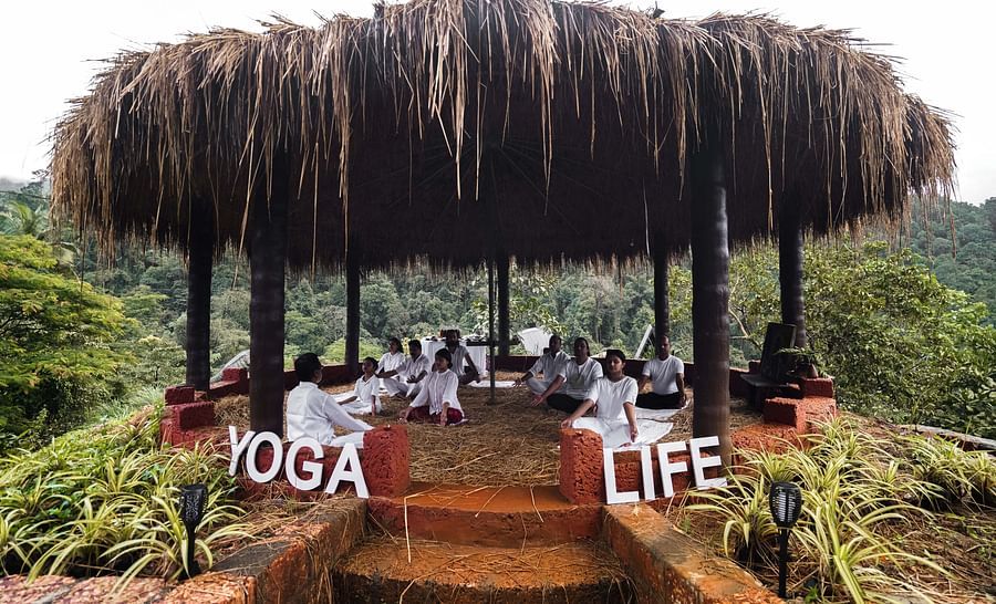 people practicing yoga in the yoga centre - Holistic Stay Eco Resort, Kannur