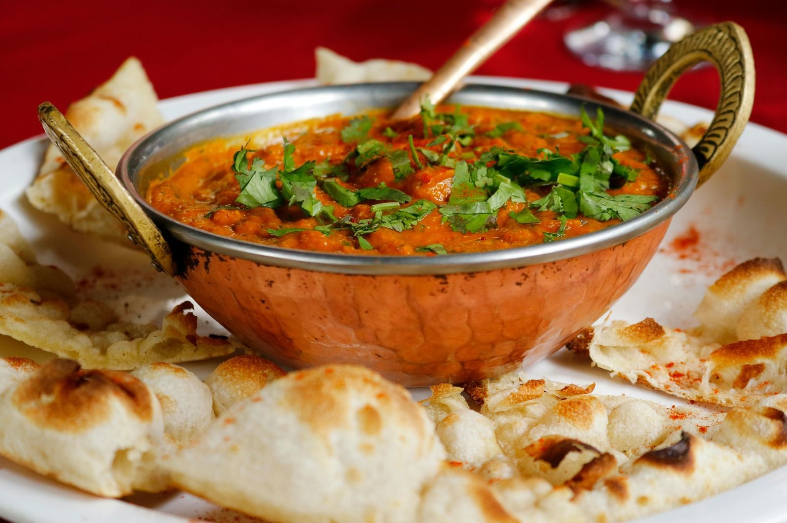 flatbread and a bowl of curry on a plate