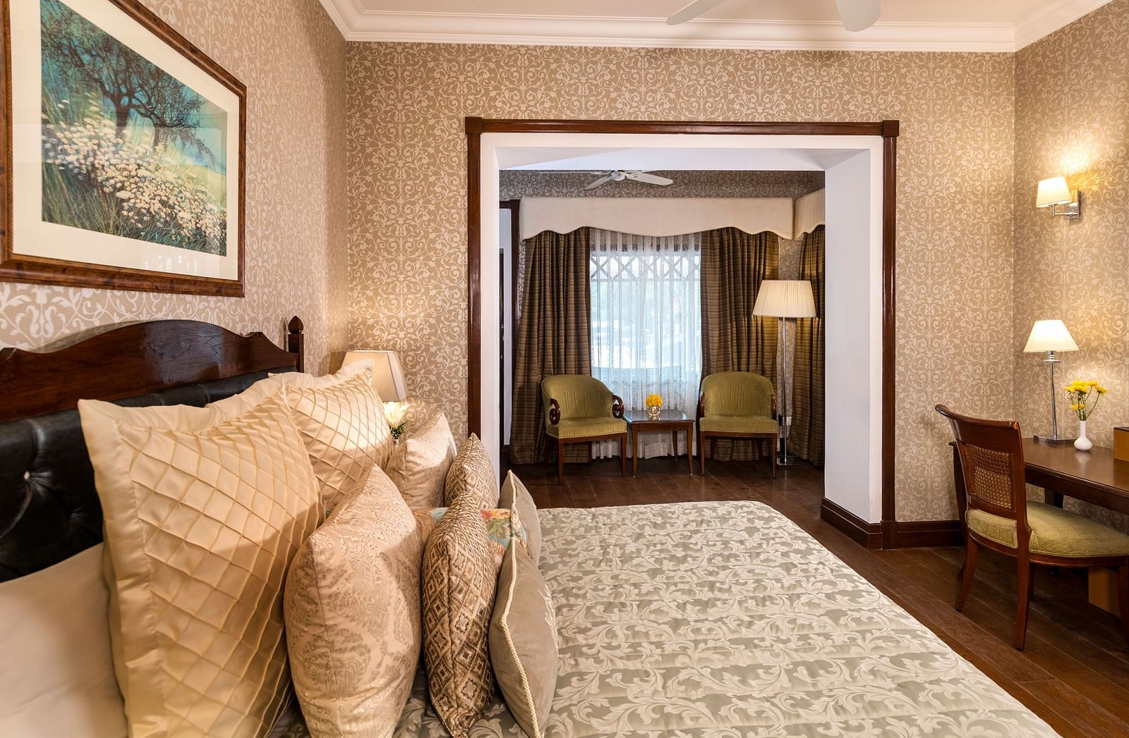 image of the king size bed and the seating area of the Club Room at The Claridges Nabha Residence