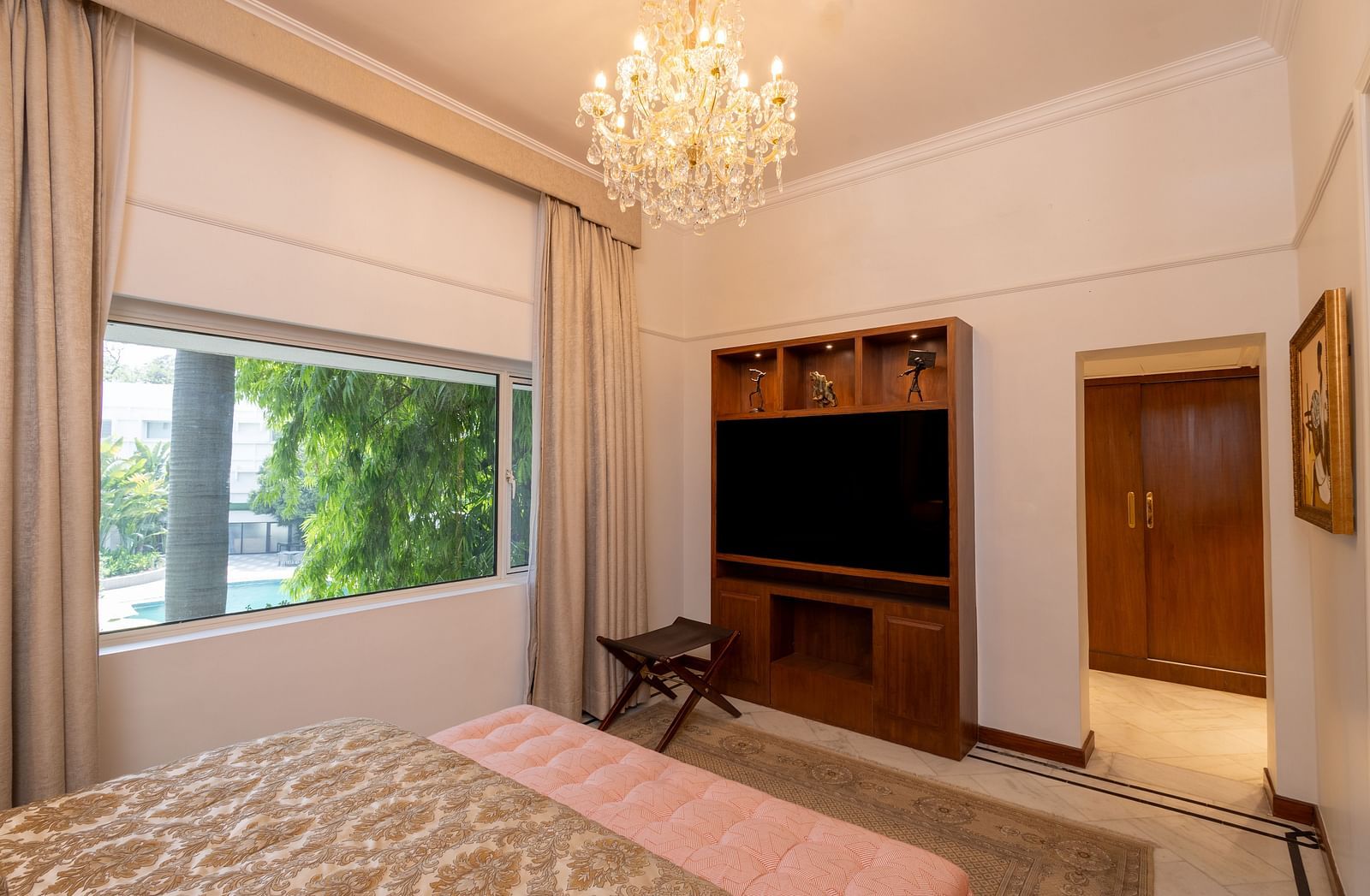 Luxury Suite at The Claridges New Delhi, showcasing an elegant chandelier hanging overhead