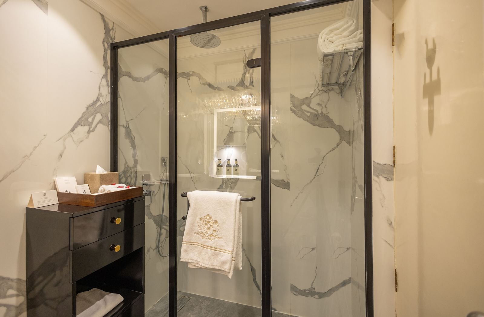 Superior King Bed Room washroom at The Claridges New Delhi, featuring a glass-enclosed bath area and a towel neatly hanging inside