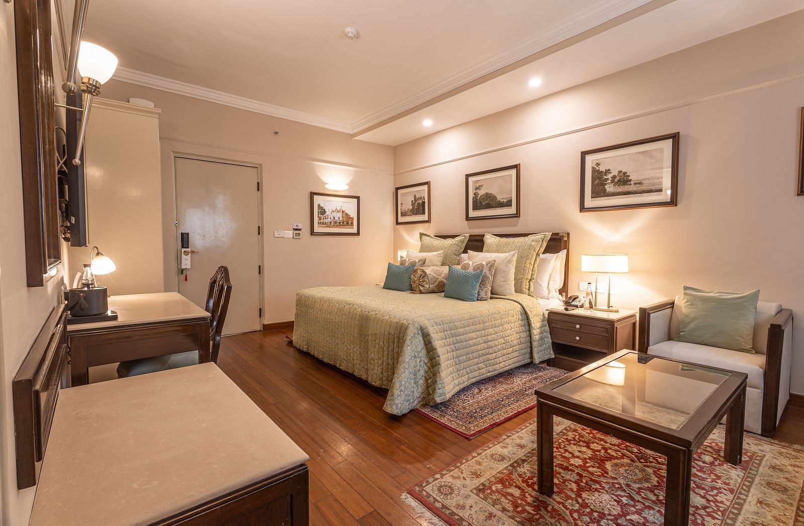 full view of the boutique room with a square glass top centre table - The Claridges New Delhi