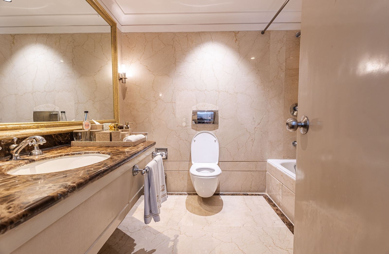 image of a bright and spacious bathroom featuring a commode at our boutique rooms - The Claridges New Delhi