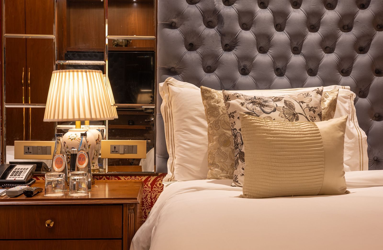 Bed in the Luxury Twin Bed Room with Balcony at The Claridges New Delhi, featuring a plush pillow and a bedside lamp