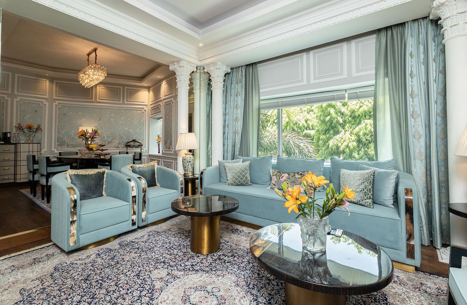 An image of the living area in our Diplomatic suite room with blue couches for comfort and elegance - The Claridges New Delhi