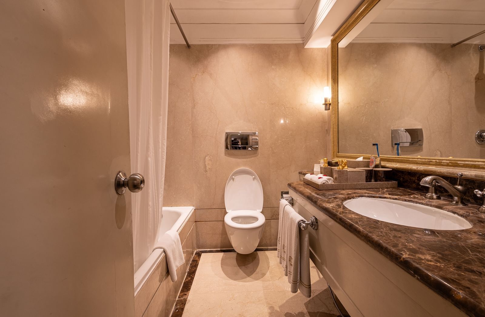 Washroom of the Superior Twin Bed Room at The Claridges New Delhi, featuring a sleek sink and a wall-mounted mirror
