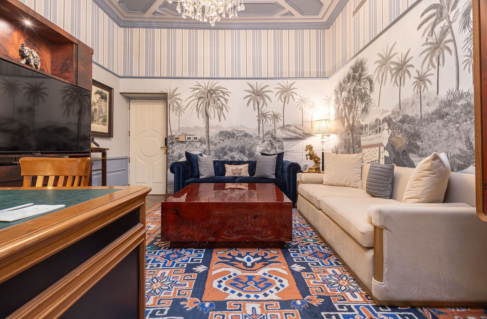 image of the living area with a dark brown centre table in a brightly lit hall at our heritage parlour suite - The Claridges New Delhi