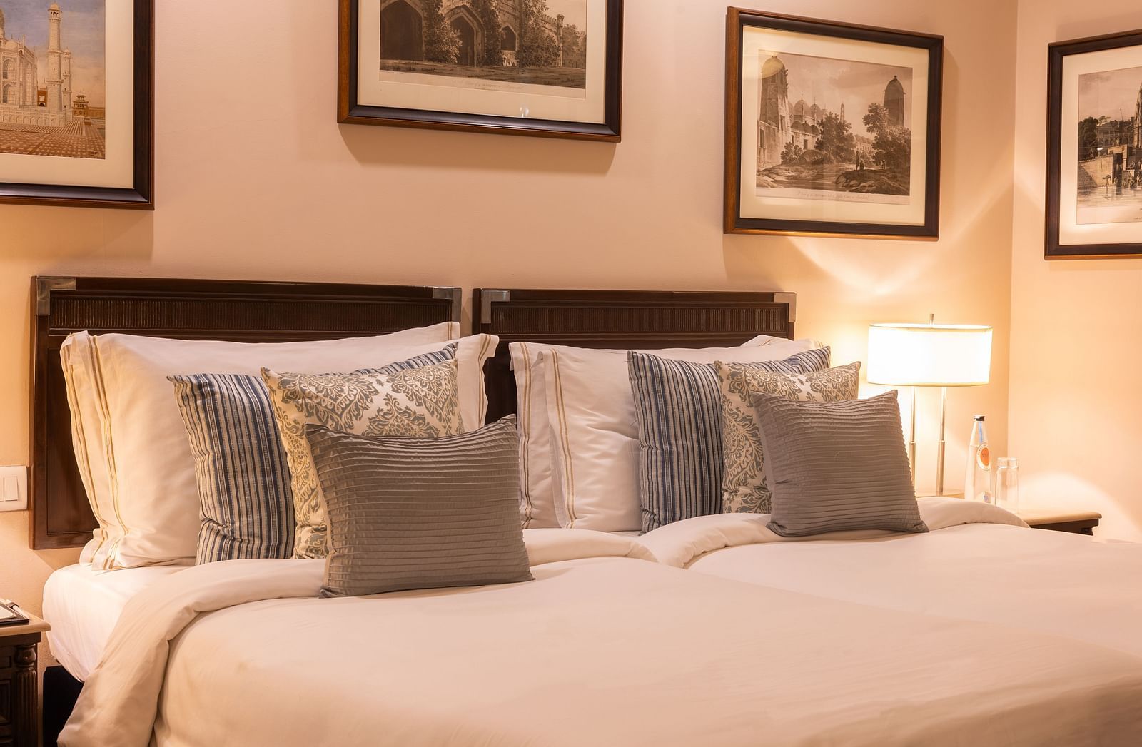 Side view of the Superior Twin Bed Room at The Claridges New Delhi, showcasing twin beds and a bedside lamp