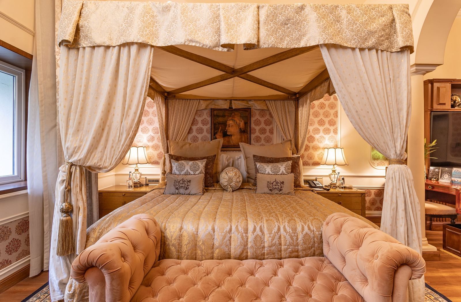 front view of the bedding of the heritage parlour suite  with a mughal style painting hung on the wall of the head board of the bed -  The Claridges New Delhi