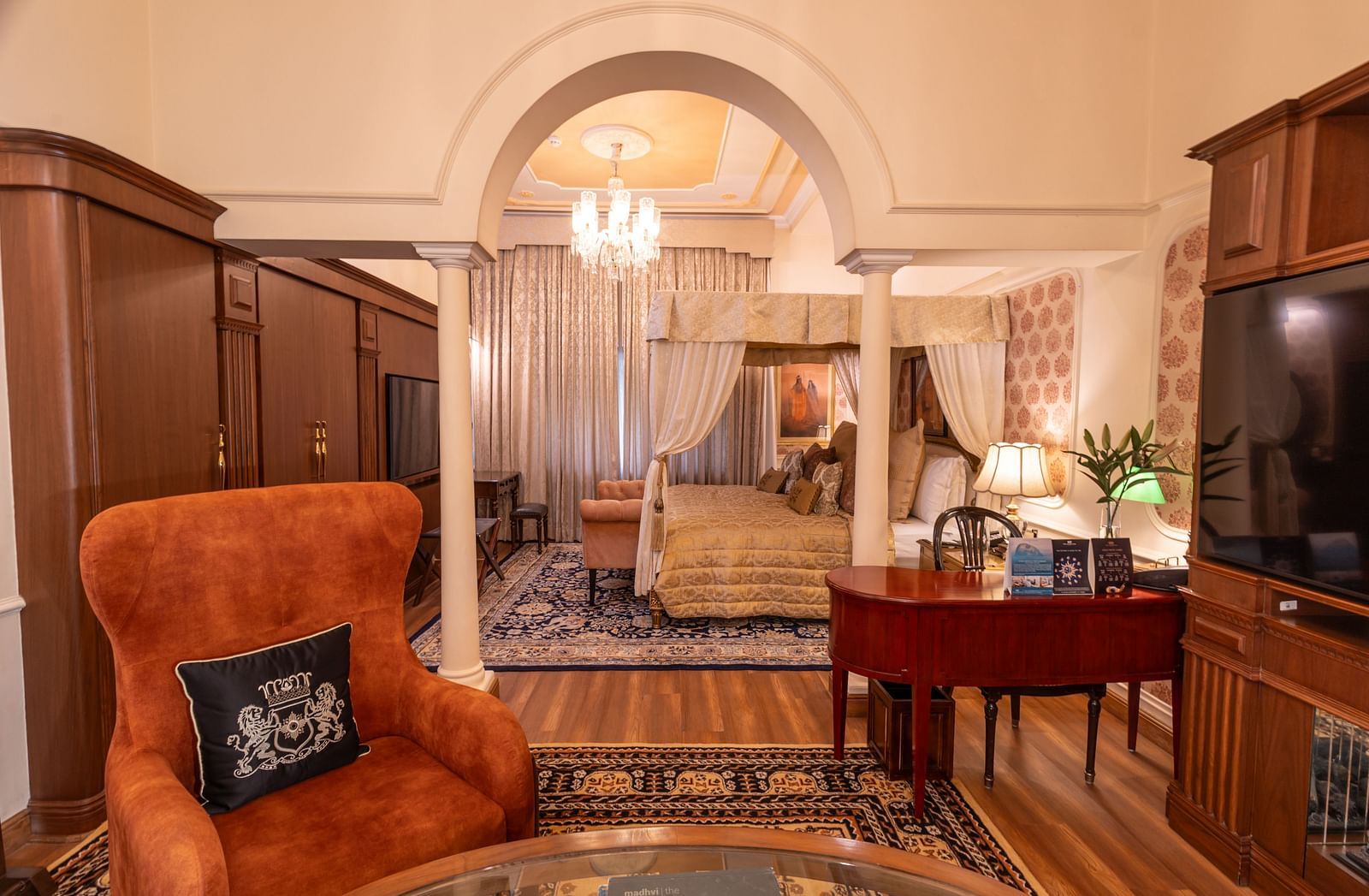 an arch shaped partition between the seating area and the bed in the bedroom of our heritage parlour suite - The Claridges New Delhi