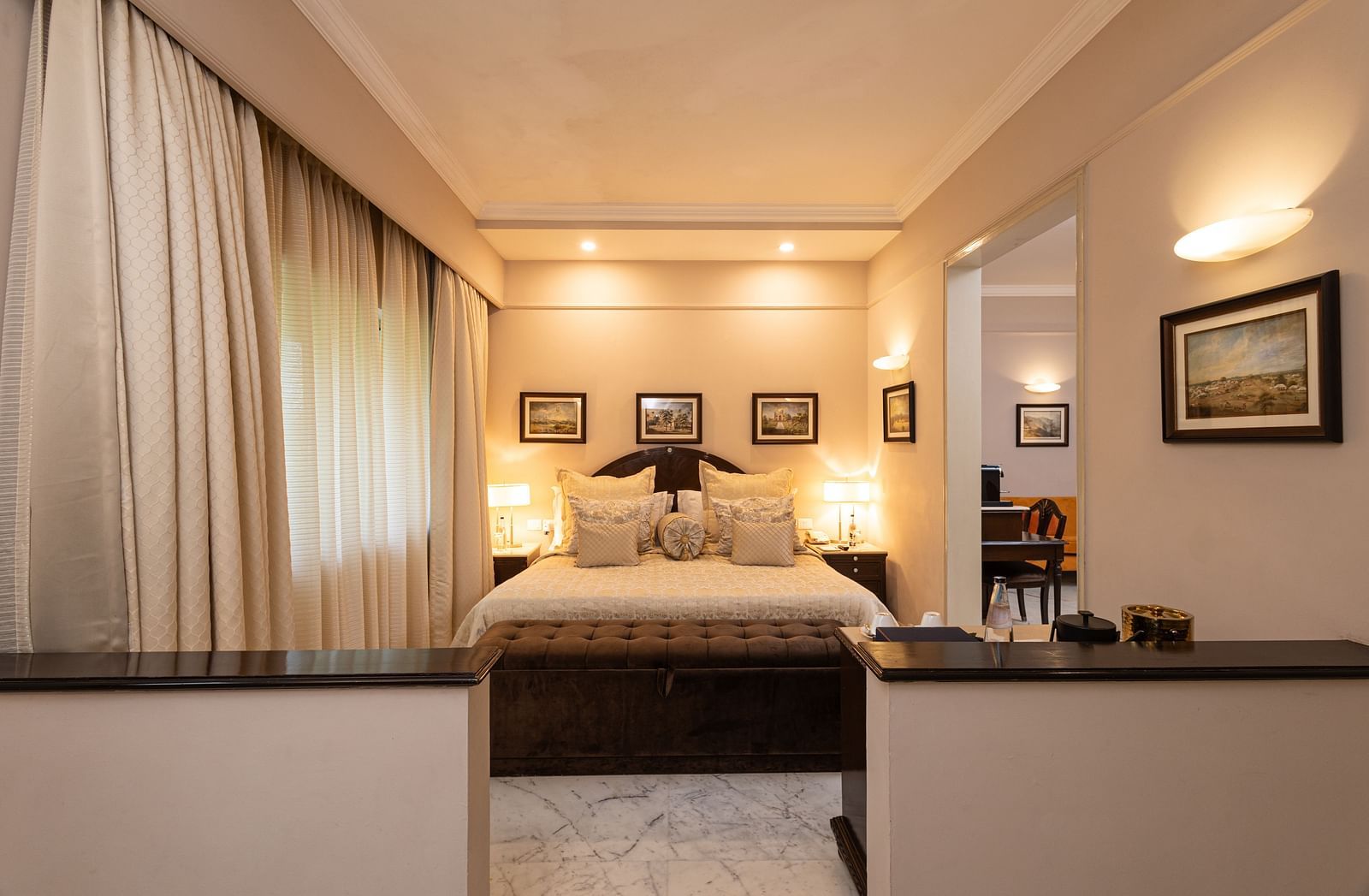 a far view of the bed with a partition towards at our heritage parlour rooms - The Claridges New Delhi