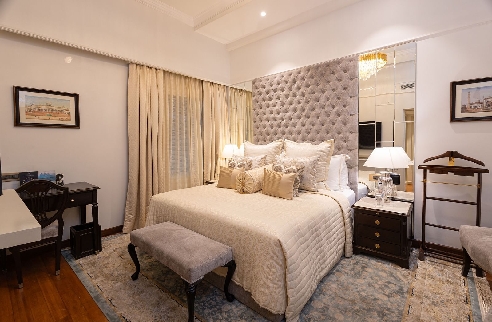 image of the boutique room featuring the king size bed with a small cushioned stool in front of it - The Claridges New Delhi