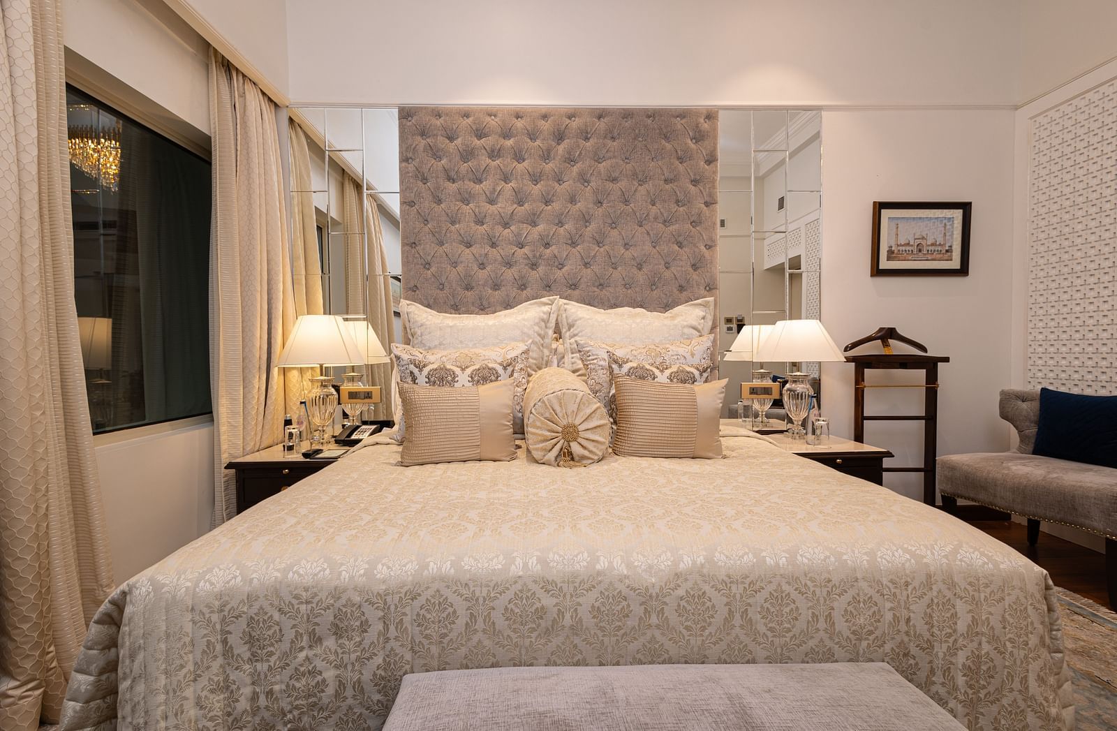 image of a plush king size bed with cushioned headboard at our boutique room - The Claridges New Delhi