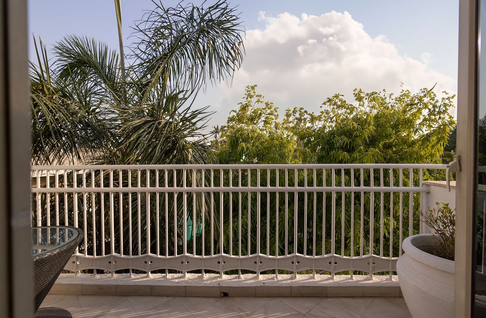 image of a beautiful spacious balcony opening to a bright space with serene green views at our heritage balcony rooms - The Claridges New Delhi