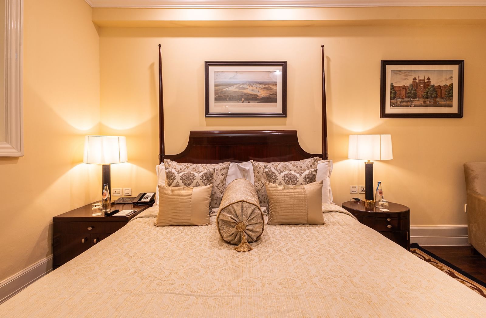 an image focusing on the bed of our heritage parlour room with table lamps on either side of the bed - The Claridges New Delhi