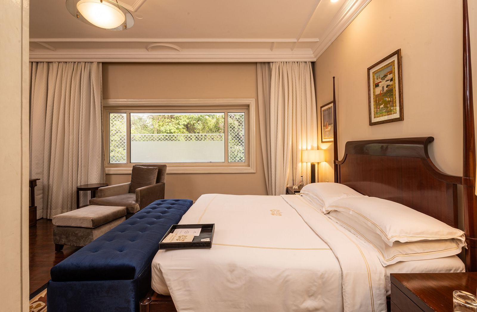 image of a heritage room bedroom with soft king sized bed and a wide window - The Claridges New Delhi