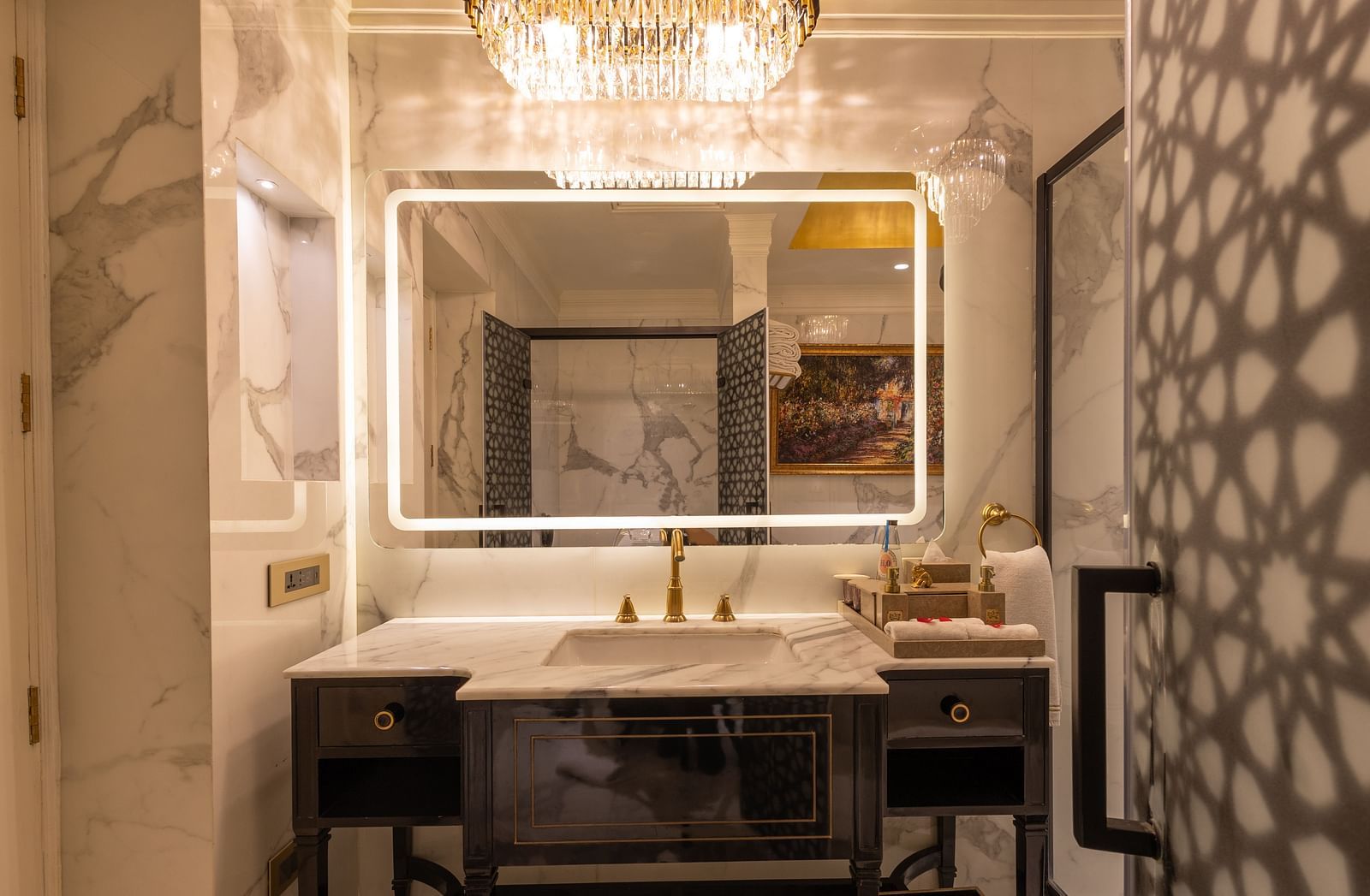 image of the attached bathroom of the heritage room focusing on the wide mirror with border lighting - The Claridges New Delhi