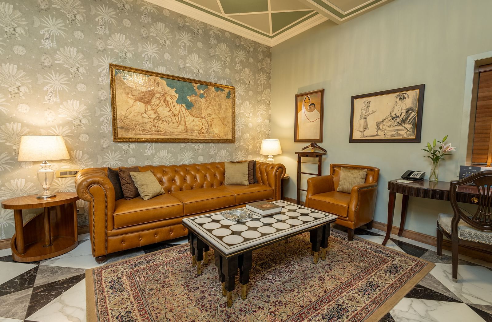 image of the living room at our heritage luxury suite with occur brown couch and a coffee table - The Claridges New Delhi