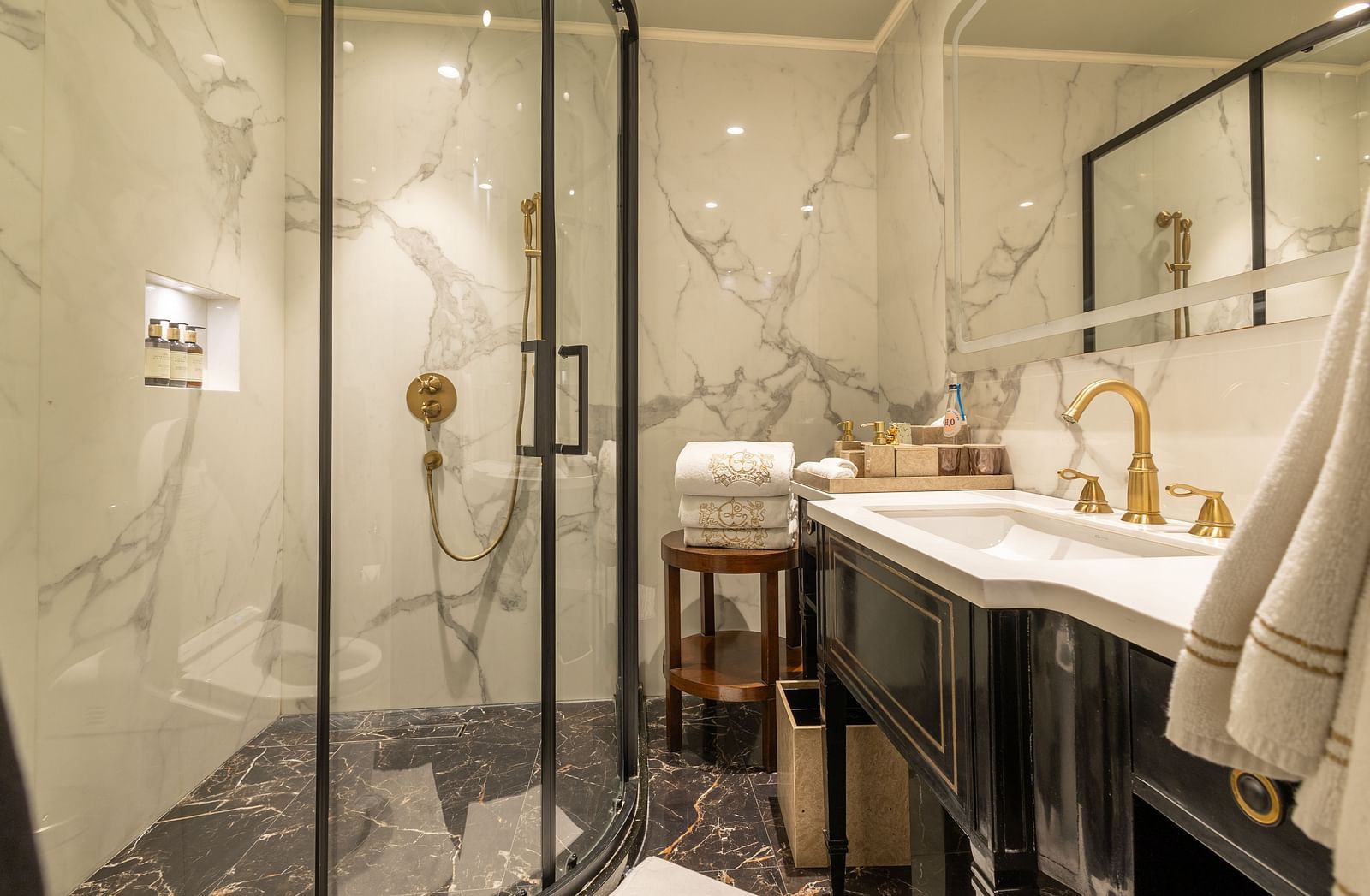 image of the bathroom with elegant decor and cubical shower at the heritage luxury suite - The Claridges New Delhi