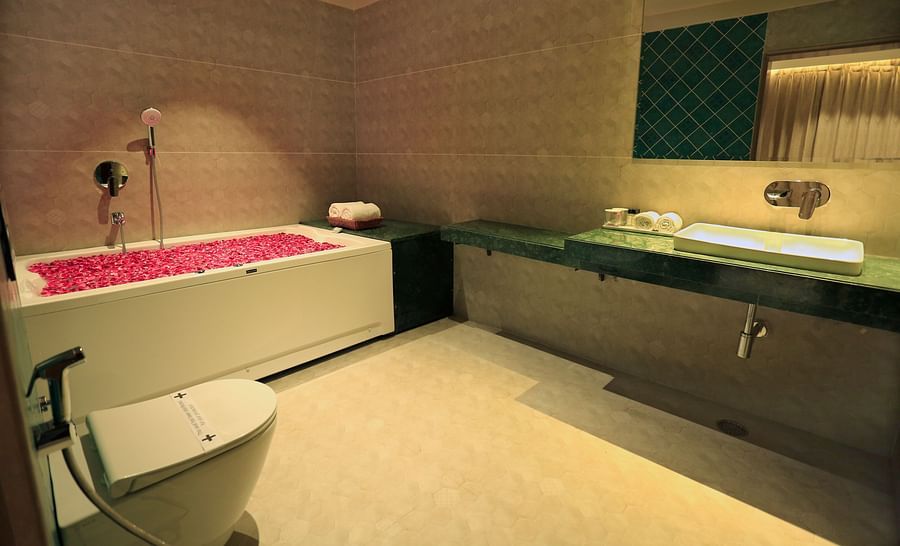 the bathtub filled with rose petals at the suite's washroom - Hotel Bawa, Udaipur