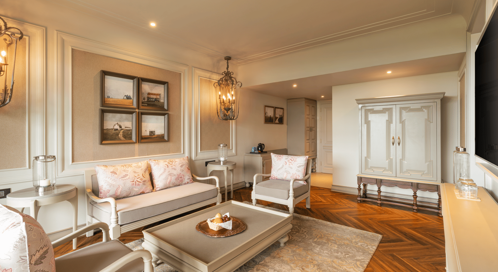A wide-angle shot of the spacious living room at the Evren Suite featuring a beautiful couch set along with a coffee table in front of it at The Evren, Vagator.