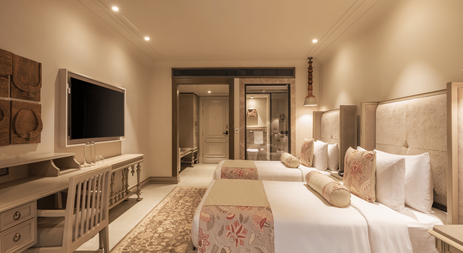 Side-view shot of the Premium Room featuring a twin bed with bright interiors at The Evren, Vagator.