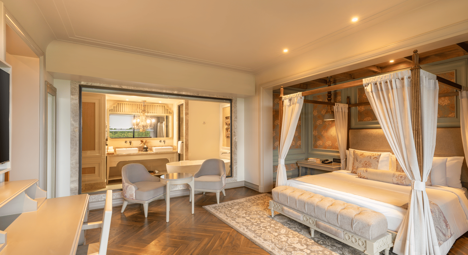 Side-view of the bedroom at the Evren Suite featuring a double bed along with a huge glass partition separating the bedroom with the bathroom at The Evren, Vagator.