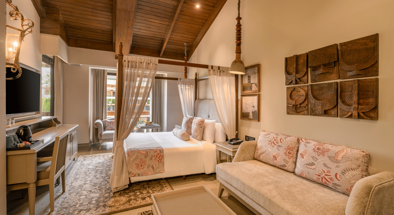 Full-view shot of the Executive Room featuring common seating area along with a double bed in the room at The Evren, Vagator.