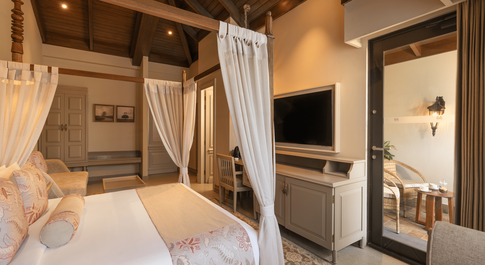 Side view of the Executive Room featuring a double bed with a television unit in front of it at The Evren, Vagator.
