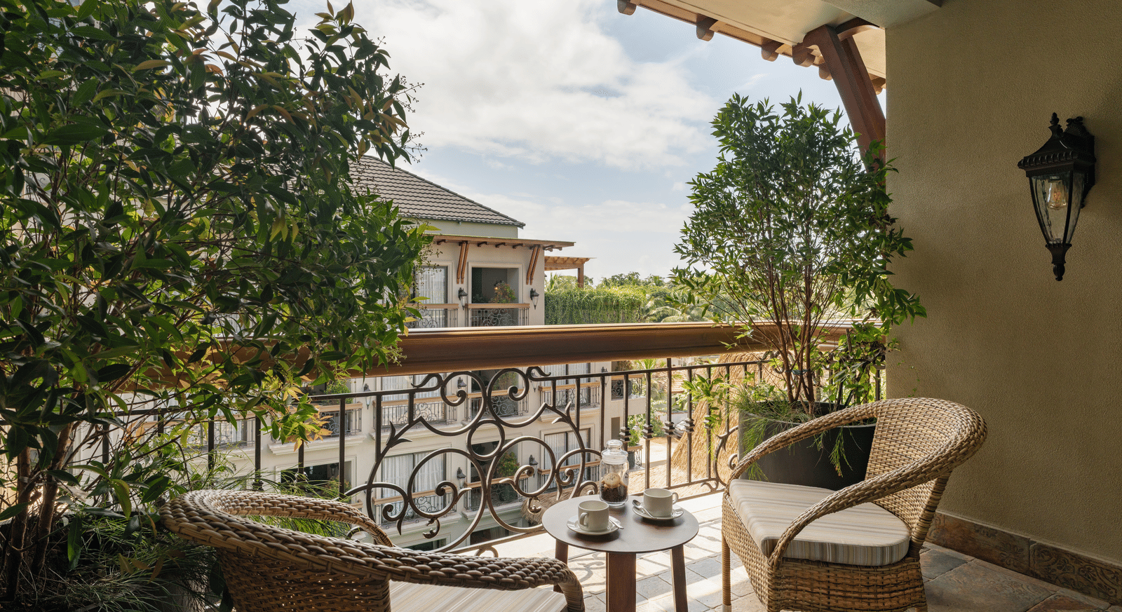 A beautiful balcony with an outdoor seating area overlooking the building opposite to it from the Premium Room at The Evren, Vagator.