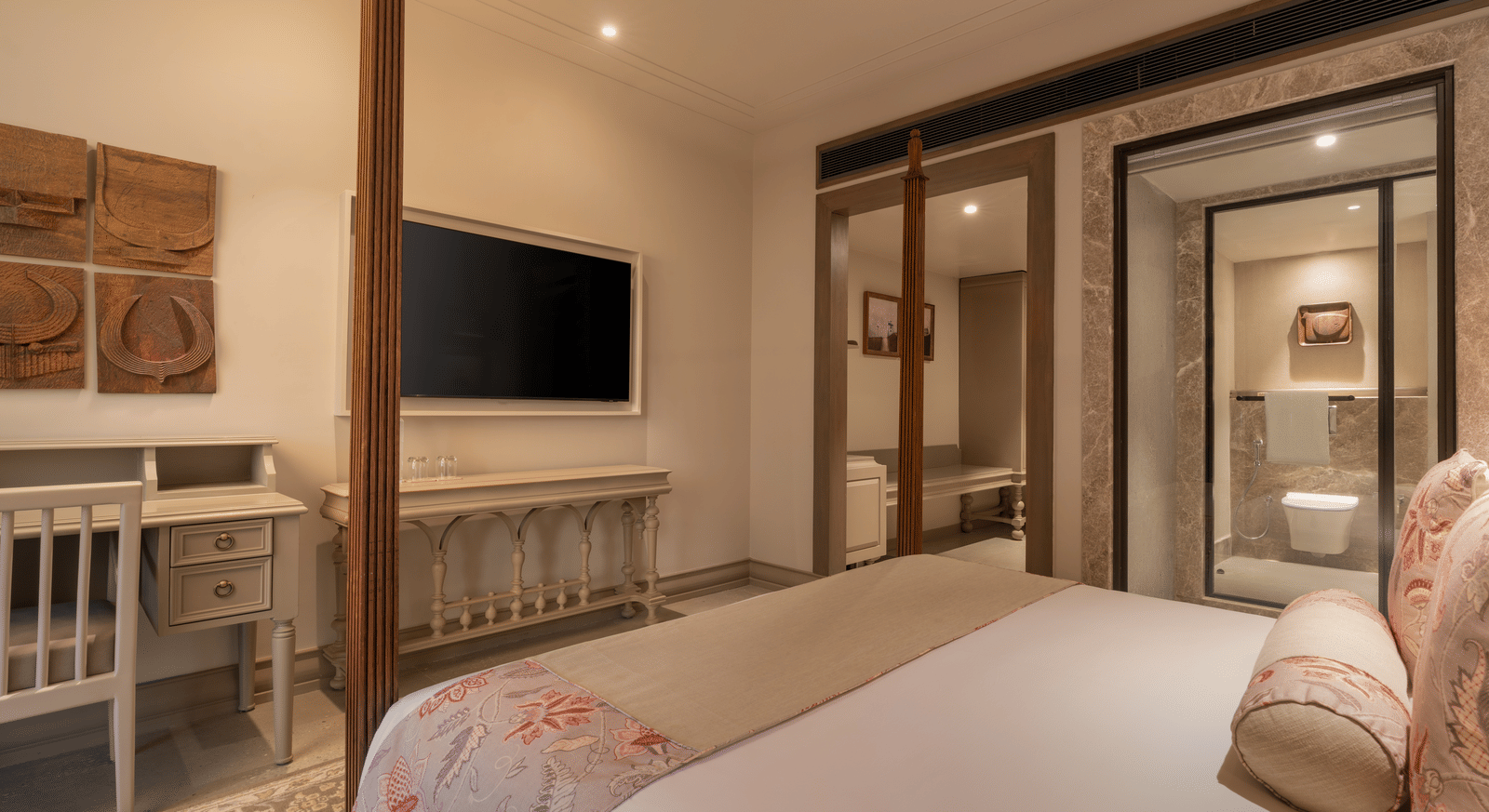 A corner view of the Claasic Room (Diwa) featuring a double bed along with a wall-mounted television in front of it at The Evren, Vagator.