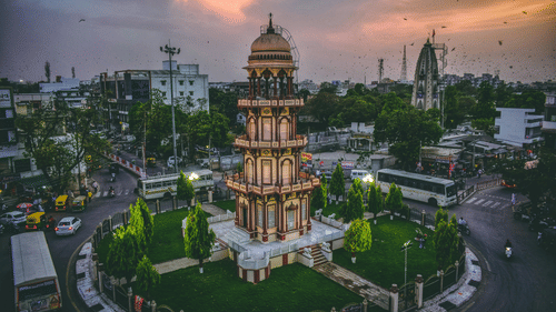 An image of a tower with tomb style tip and three storeys beneath and the tower is located at the centre of four roads connected to each other