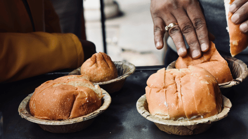 Butter bun and samosa served in a leaf cup