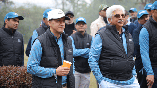 A group of people in similar attire gathered in a golf course for the game day - Heritage Village Resorts & Spa
