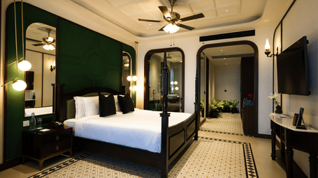 Elegant bedroom of the Sohra Family Suite with vintage interiors and ceiling fan, offering a comfortable stay at Polo Resort Cherrapunji.